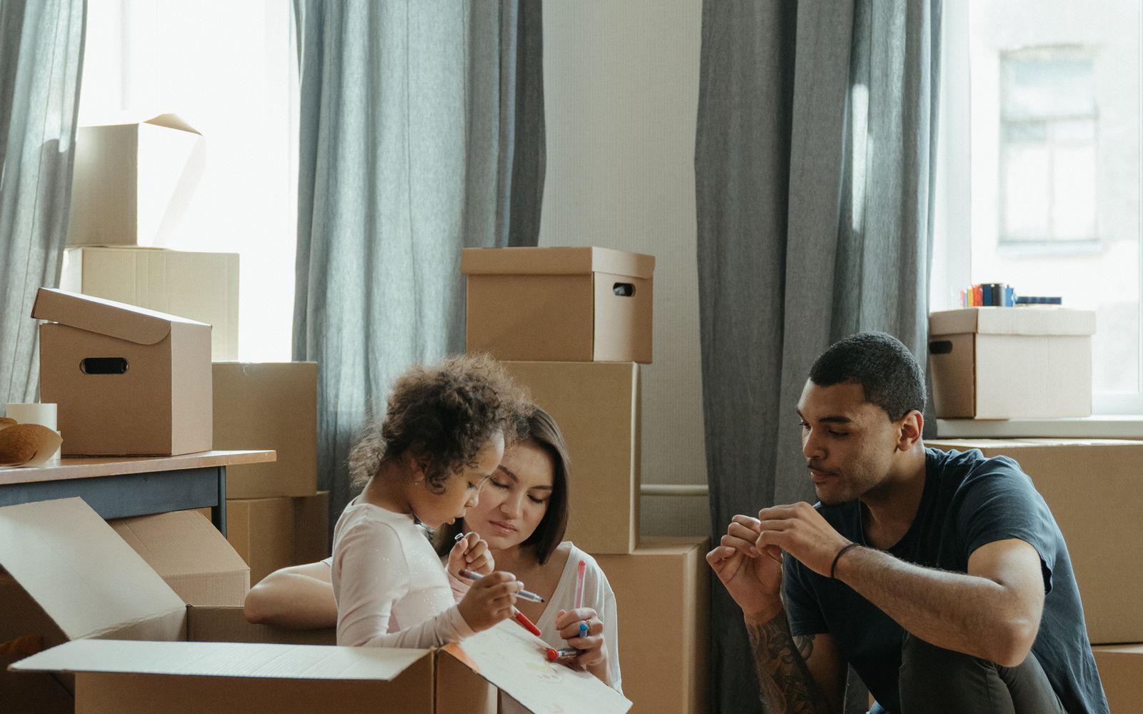 Family packing moving boxes before listing their house