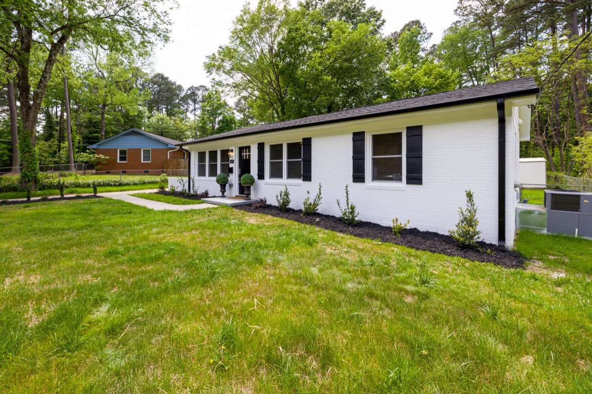 Small ranch-style house with a wide grassy yard