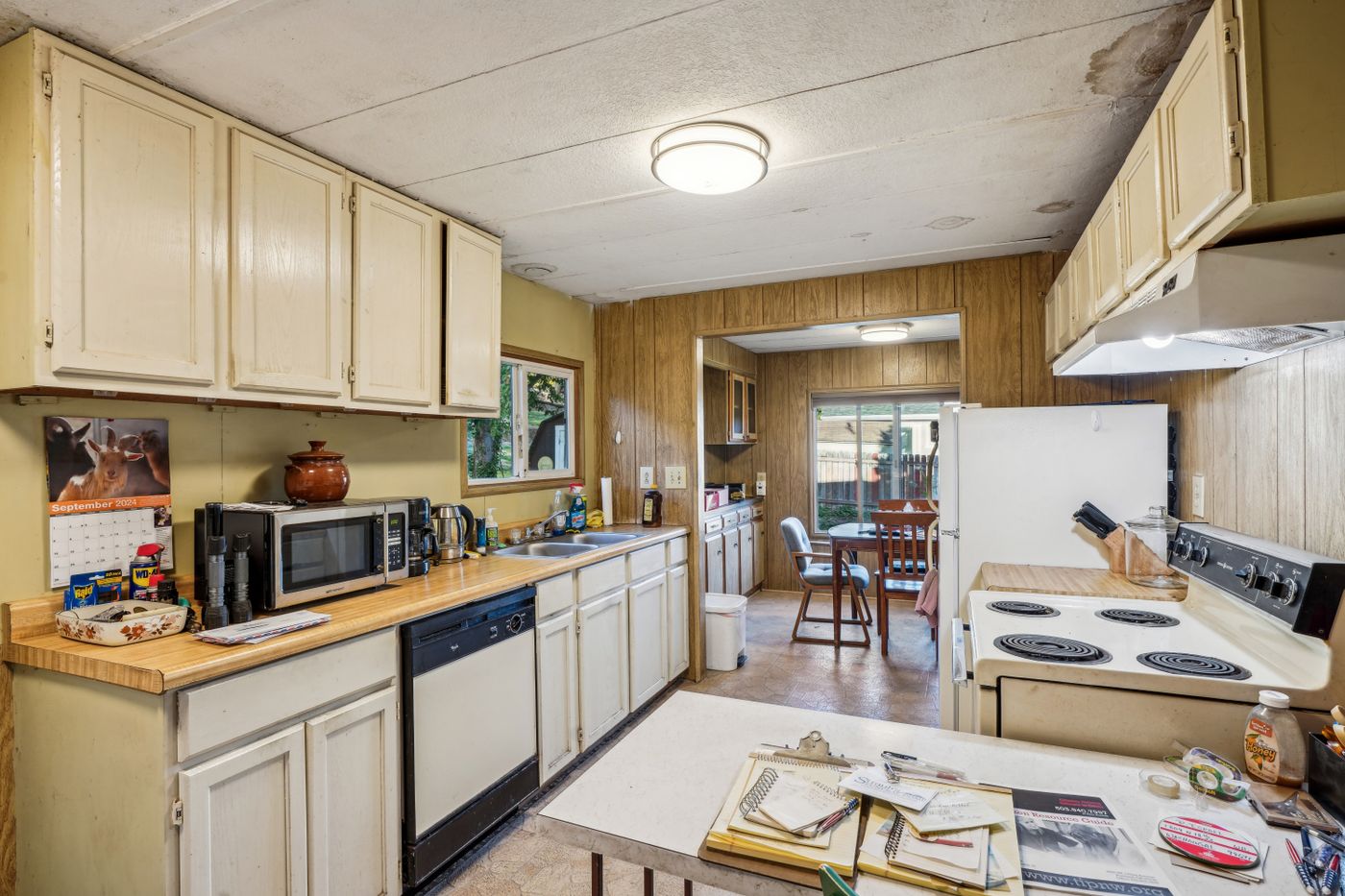Dated kitchen with original oak cabinets and older appliances