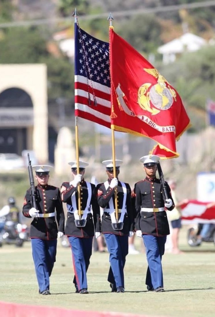 Marine Corps color guard carrying the American flag and 1st Radio Battalion colors
