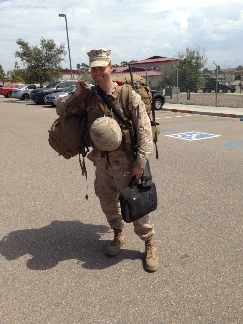 Wade Bartels in Marine Corps utilities carrying deployment gear