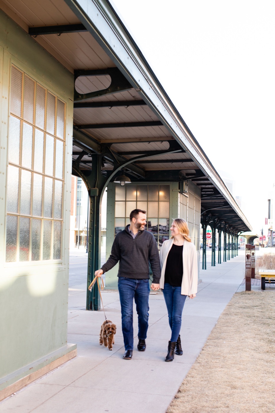 Wade and Kelsey Bartels walking their dog in downtown Lincoln