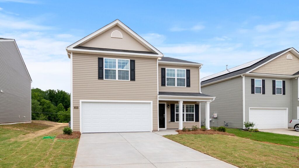 Contemporary two-story suburban home with a spacious driveway and lawn.