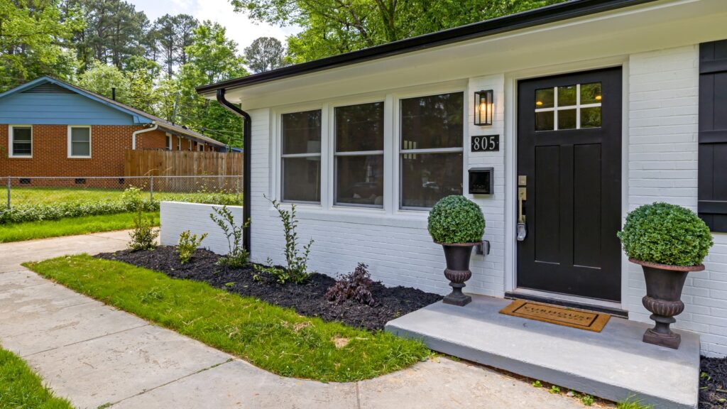 Charming modern suburban house with a landscaped front yard and welcoming entrance.